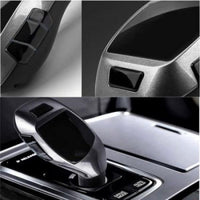 Încărcați imaginea în vizualizatorul Galeriei, Close-up of a car's gear shift lever and surrounding interior details.
